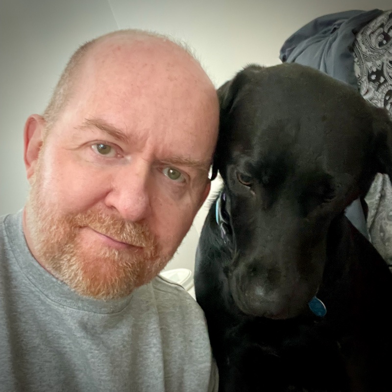Ron and his black Labrador, Philly, cheek to cheek.